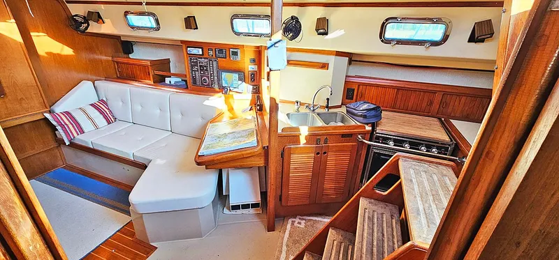 Slide: The Image of Interior of 1988 Island Packet 38 sailboat with cozy seating and kitchen area. - 2