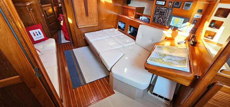 Slide: The Image of Interior of 1988 Island Packet 38 sailboat with navigation station and seating area. - 3
