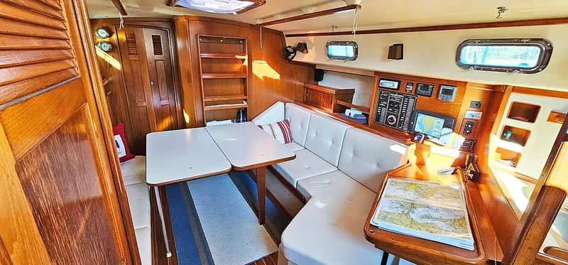 Slide: The Image of Interior of 1988 Island Packet 38 sailboat with wooden cabinetry and navigation station. - 4