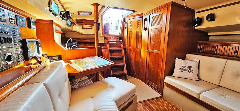 Slide: The Image of Interior of 1988 Island Packet 38 sailboat with cozy seating and navigation area. - 5