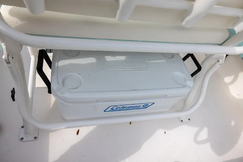 Slide: The Image of White Coleman cooler on 2023 Robalo 246 Cayman boat deck. - 11
