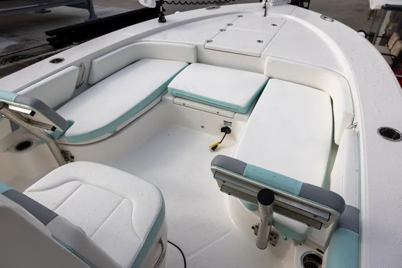 Slide: The Image of 2023 Robalo 246 Cayman boat interior with white and teal seating. - 17
