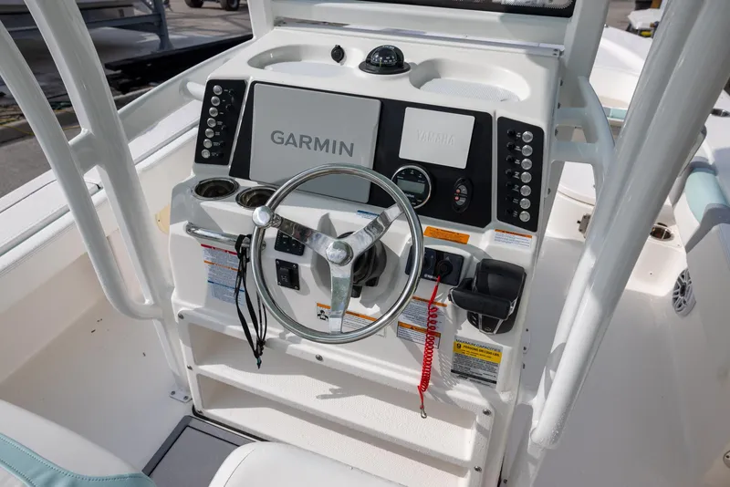 Slide: The Image of 2023 Robalo 246 Cayman boat dashboard with Garmin navigation system and steering wheel. - 8