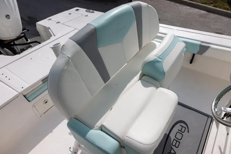 Slide: The Image of 2023 Robalo 246 Cayman boat seat with white and teal upholstery. - 9