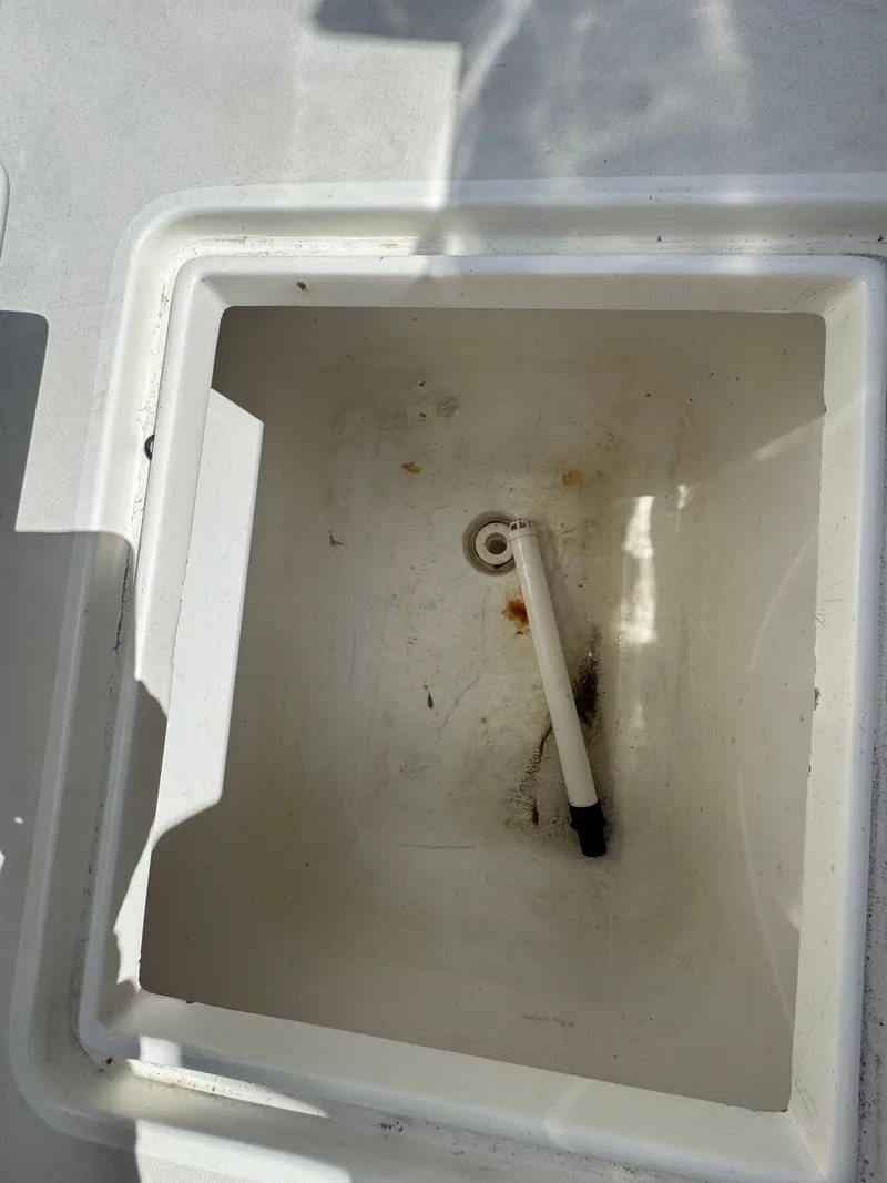 Slide: The Image of Storage compartment of a 1996 Intrepid 356 Cuddy boat, showing interior details. - 12