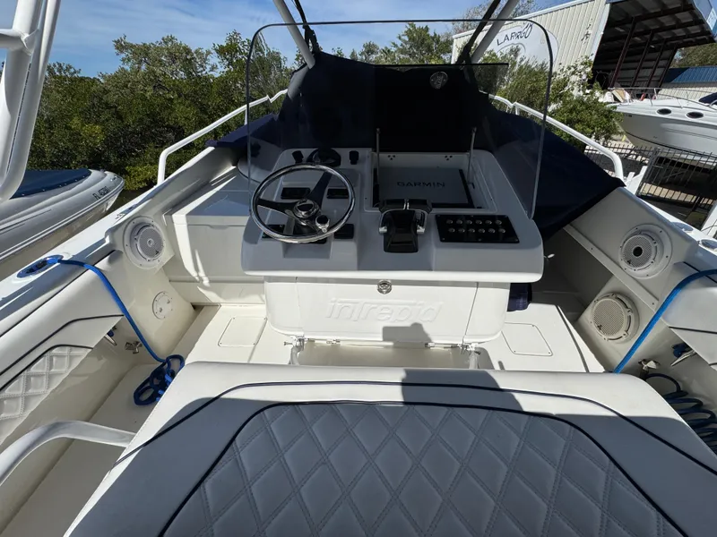 Slide: The Image of 1996 Intrepid 356 Cuddy boat cockpit with steering wheel and Garmin navigation system. - 13