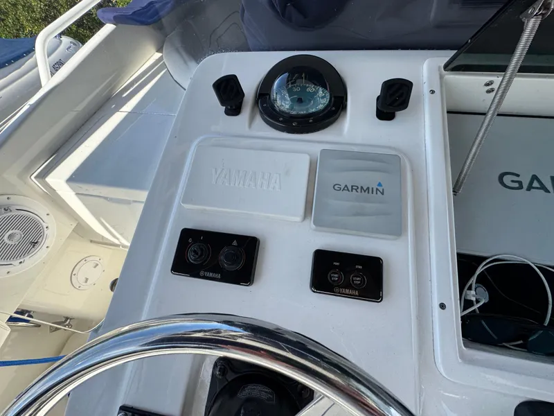 Slide: The Image of Boat dashboard with Yamaha and Garmin controls on a 1996 Intrepid 356 Cuddy. - 23