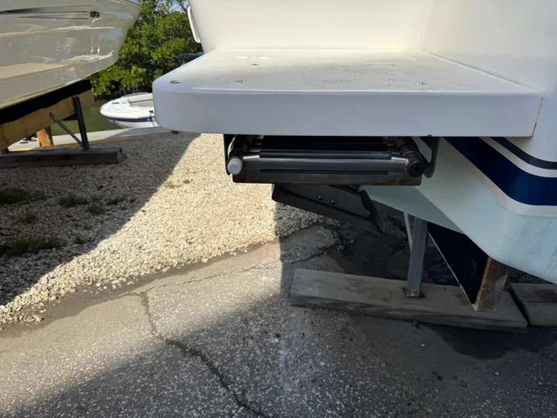 Slide: The Image of 1996 Intrepid 356 Cuddy swim platform with retractable ladder, docked on gravel. - 25