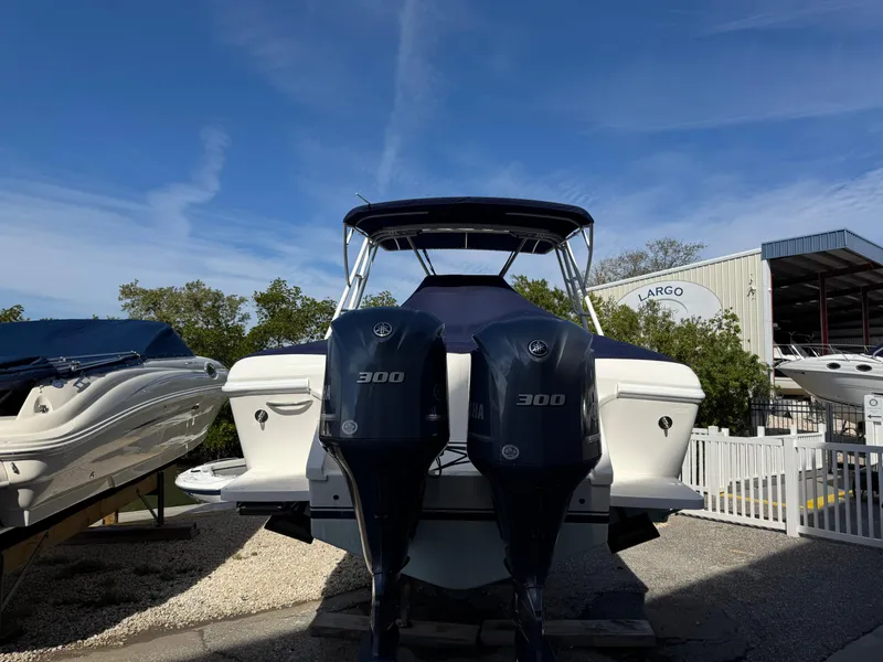 Slide: The Image of 1996 Intrepid 356 Cuddy boat with dual 300 horsepower engines, docked outdoors. - 26
