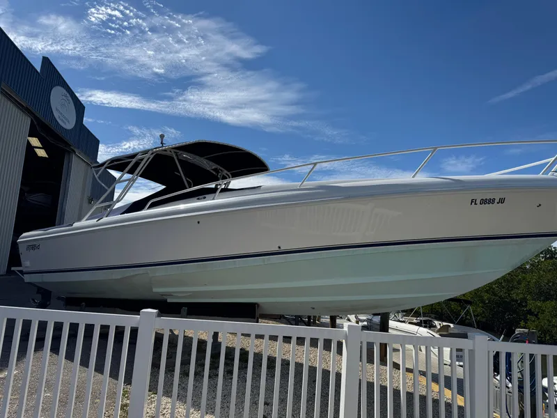 Slide: The Image of 1996 Intrepid 356 Cuddy boat on display outside a marine facility. - 27