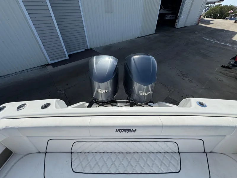 Slide: The Image of 1996 Intrepid 356 Cuddy boat with twin Yamaha 300 engines at a dock. - 7