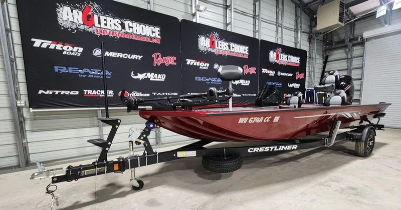 Slide: The Image of 2024 Crestliner XF 189 boat on trailer in showroom with Anglers Choice backdrop. - 4