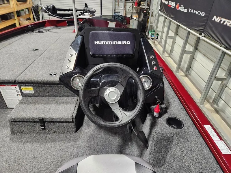 Slide: The Image of 2024 Crestliner XF 189 boat interior with steering wheel and Humminbird electronics. - 6