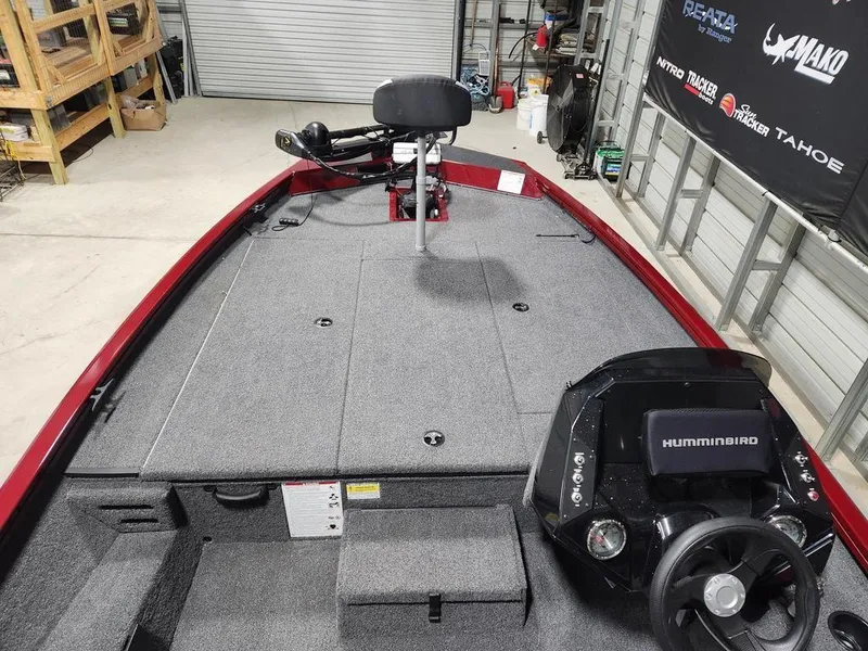 Slide: The Image of 2024 Crestliner XF 189 fishing boat interior with Humminbird electronics in a garage setting. - 7