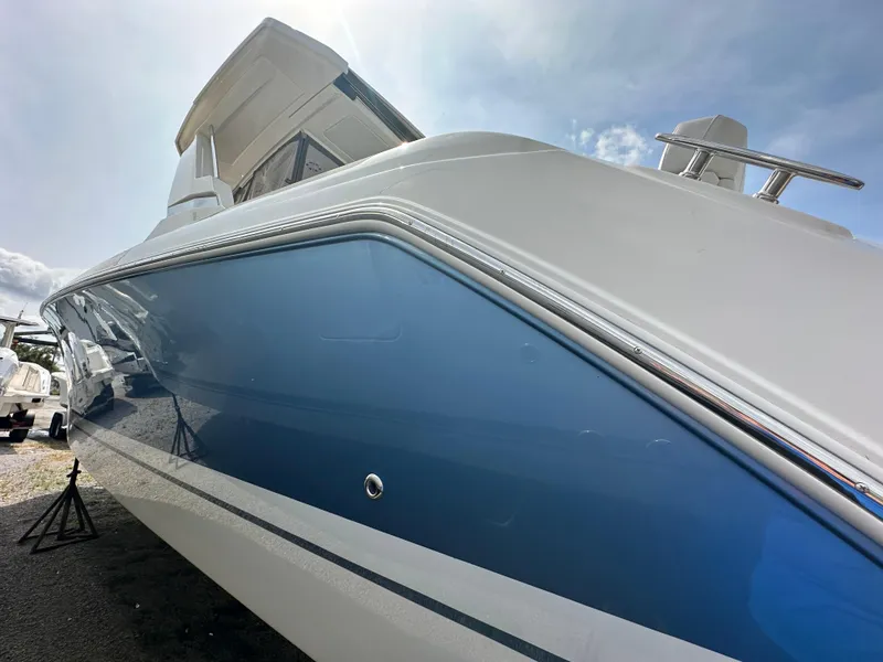 Slide: The Image of 2025 Tiara Yachts 34 LS with sleek blue and white design under a clear sky. - 11