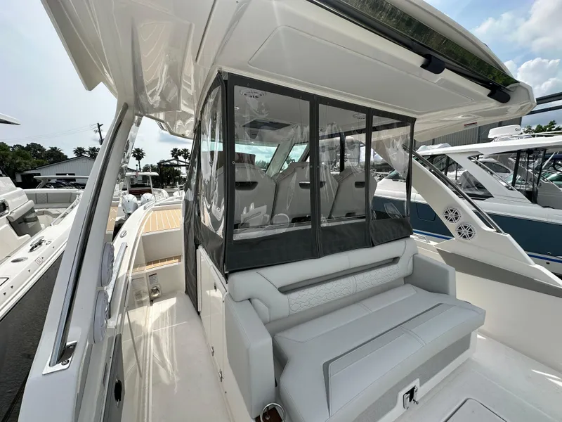 Slide: The Image of 2025 Tiara Yachts 34 LS luxury boat interior with seating and protective enclosure. - 17