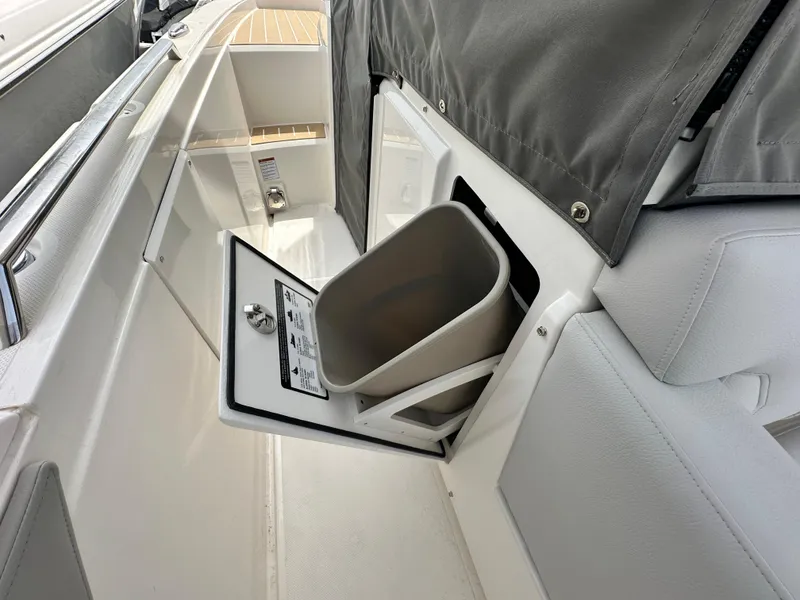 Slide: The Image of 2025 Tiara Yachts 34 LS interior with open storage compartment and trash bin. - 20