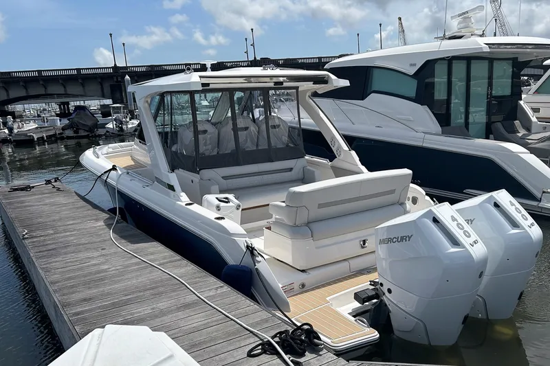 Slide: The Image of 2025 Tiara Yachts 34 LS docked, featuring dual Mercury outboard engines. - 3