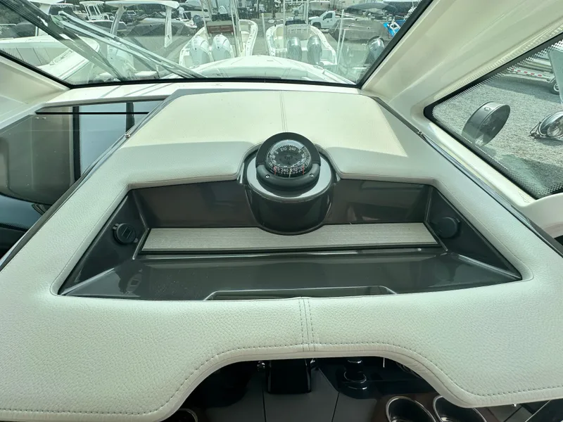 Slide: The Image of 2025 Tiara Yachts 34 LS dashboard with compass, sleek design, and modern features. - 32