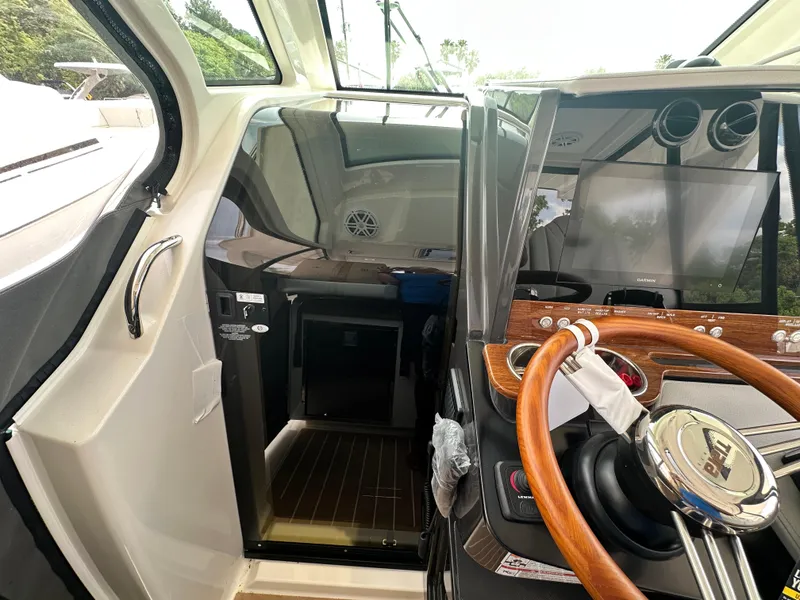 Slide: The Image of 2025 Tiara Yachts 34 LS cockpit with modern steering and sleek interior design. - 33