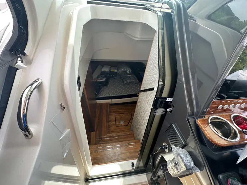 Slide: The Image of 2025 Tiara Yachts 34 LS cabin entrance with wooden flooring and modern interior design. - 34
