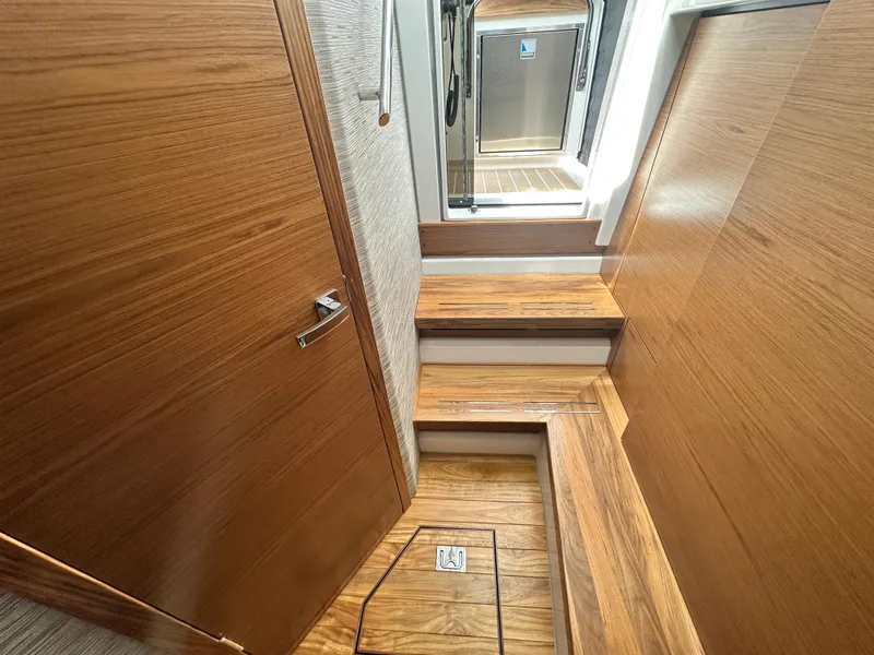 Slide: The Image of Interior of 2025 Tiara Yachts 34 LS, featuring wooden stairs and sleek design. - 35