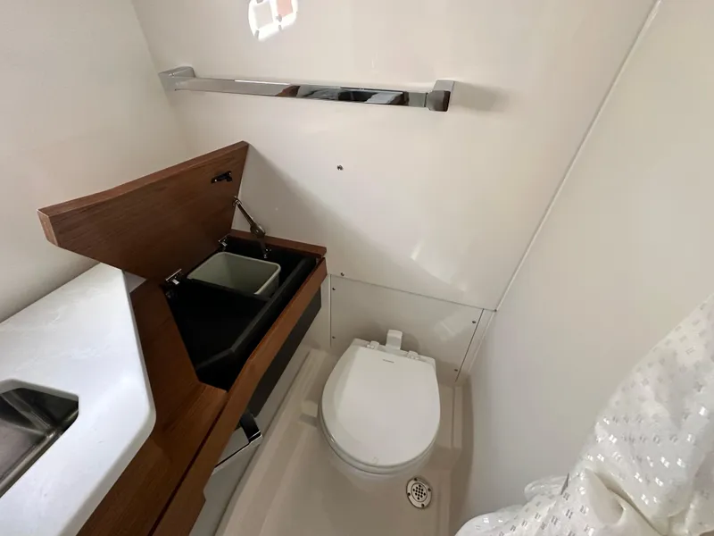 Slide: The Image of 2025 Tiara Yachts 34 LS bathroom with modern fixtures and wooden cabinetry. - 40