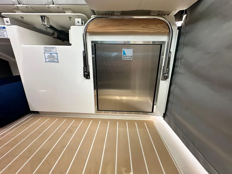 Slide: The Image of 2025 Tiara Yachts 34 LS interior with stainless steel door and wood-accented flooring. - 41