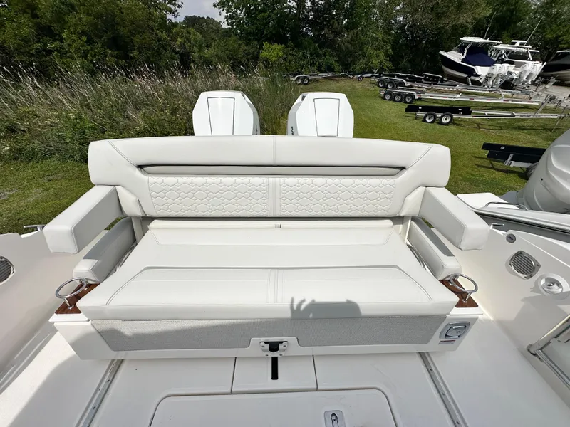 Slide: The Image of 2025 Tiara Yachts 34 LS boat with white cushioned seating and dual outboard motors. - 44