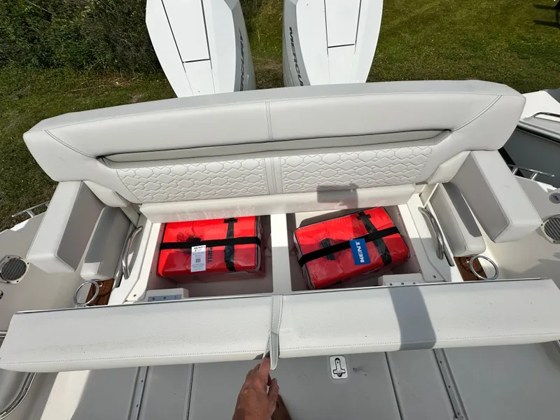 Slide: The Image of 2025 Tiara Yachts 34 LS with open storage, revealing red life jackets. - 45