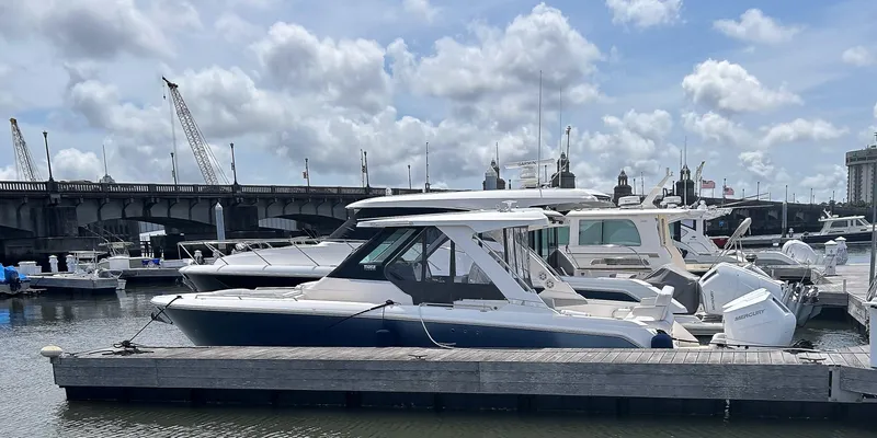 Slide: The Image of 2025 Tiara Yachts 34 LS docked at marina under cloudy sky. - 5