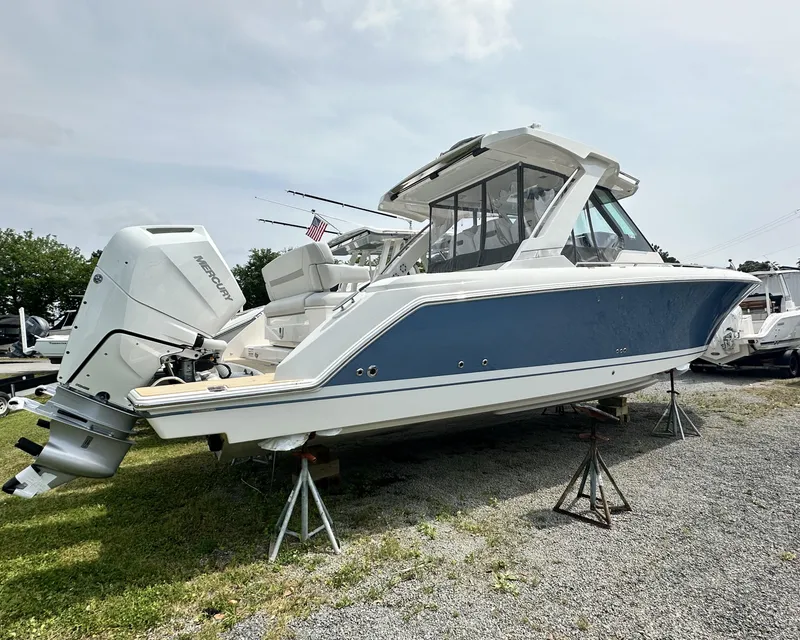 Slide: The Image of 2025 Tiara Yachts 34 LS boat with outboard motor on display outdoors. - 7