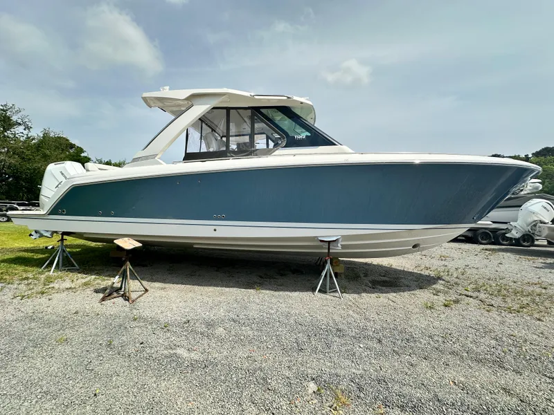 Slide: The Image of 2025 Tiara Yachts 34 LS boat on stands, side view, outdoors. - 9