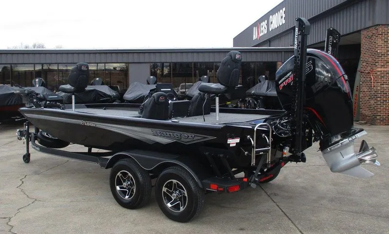 Slide: The Image of 2024 Ranger RT198P boat, black, parked outside a dealership, showcasing sleek design and powerful engine. - 3