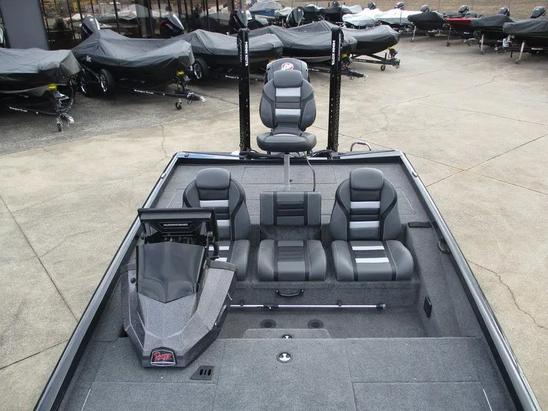 Slide: The Image of 2024 Ranger RT198P boat interior with seating and console, displayed outdoors. - 5