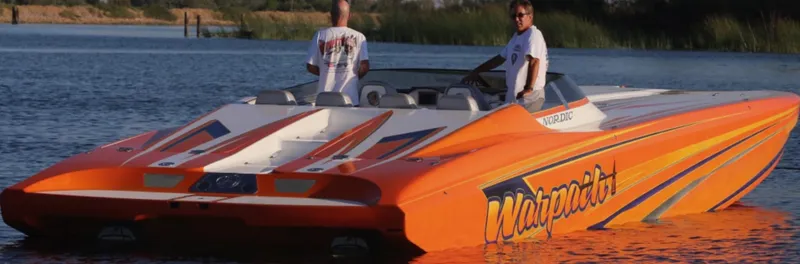 The Image of 2014 Nordic Powerboats 43 Enforcer in vibrant orange on calm water. - 1