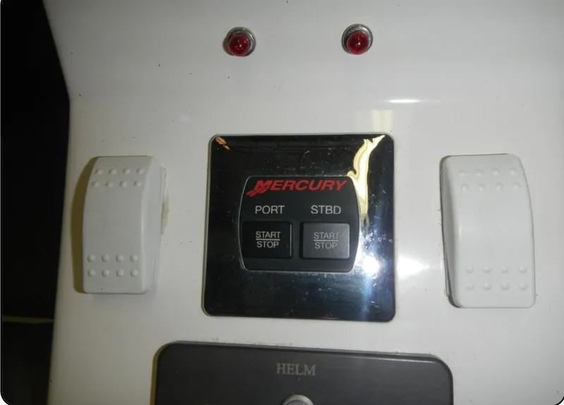 Slide: The Image of Control panel of a 2014 Nordic Powerboats 43 Enforcer with Mercury start/stop buttons. - 10
