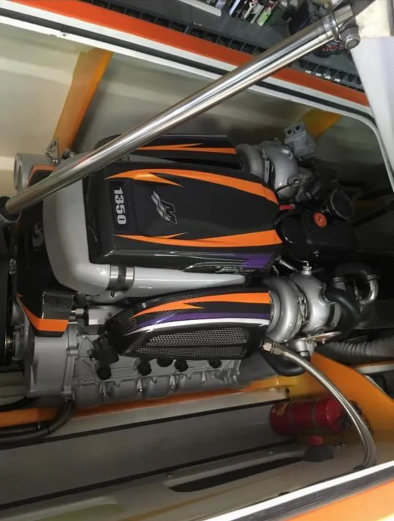 Slide: The Image of Engine of 2014 Nordic Powerboats 43 Enforcer, featuring vibrant orange and black design. - 14