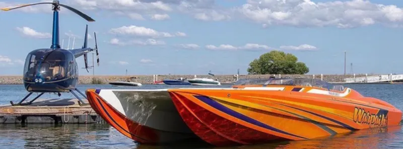 Slide: The Image of 2014 Nordic Powerboats 43 Enforcer in vibrant colors docked beside a helicopter. - 20