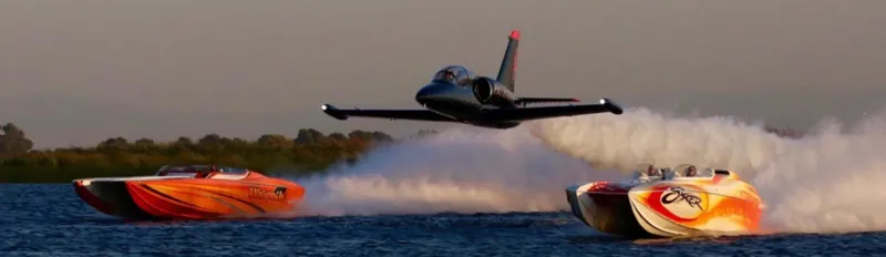 Slide: The Image of High-speed Nordic Powerboats 43 Enforcer racing with a jet overhead on open water. - 22