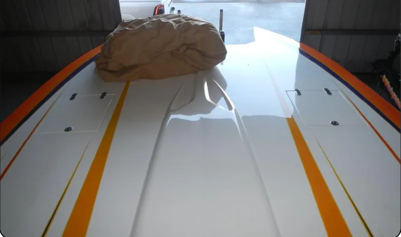 Slide: The Image of 2014 Nordic Powerboats 43 Enforcer with sleek design and vibrant orange stripes. - 4