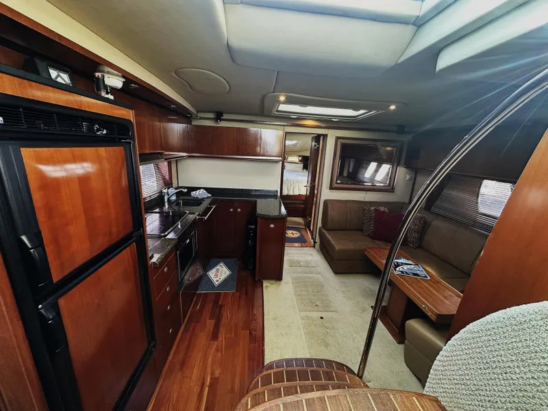 Slide: The Image of Interior of 2006 Sea Ray 48 Sundancer yacht with modern kitchen and seating area. - 12