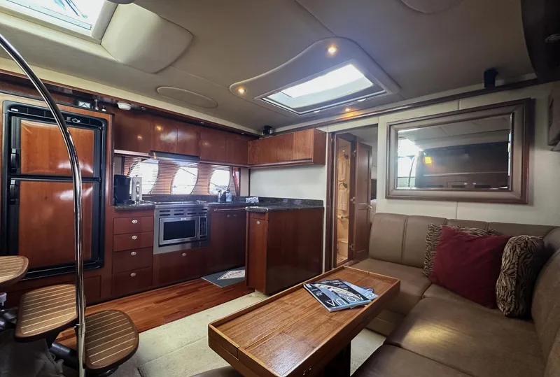 Slide: The Image of Luxurious interior of 2006 Sea Ray 48 Sundancer yacht with modern kitchen and cozy seating area. - 13
