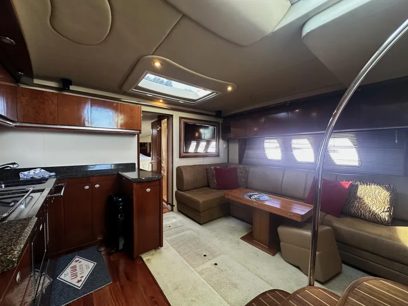 Slide: The Image of Luxurious interior of 2006 Sea Ray 48 Sundancer yacht with modern kitchen and cozy seating area. - 14