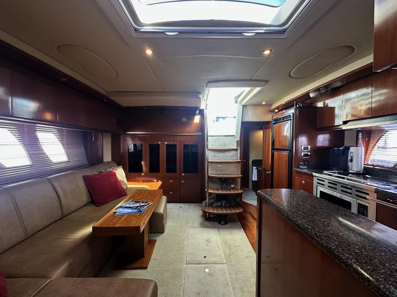 Slide: The Image of Luxurious interior of 2006 Sea Ray 48 Sundancer yacht with modern kitchen and seating area. - 16
