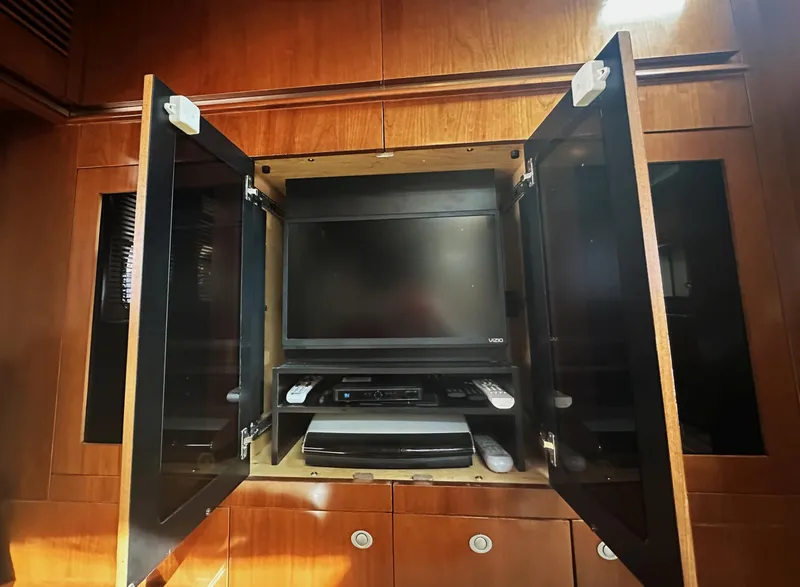 Slide: The Image of Entertainment center with TV and electronics on 2006 Sea Ray 48 Sundancer yacht. - 19