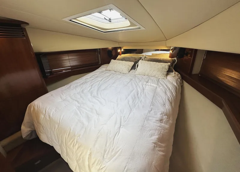 Slide: The Image of Luxurious bedroom interior of 2006 Sea Ray 48 Sundancer yacht with skylight and cozy bedding. - 20