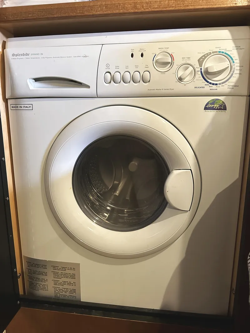 Slide: The Image of Front-loading washing machine in a wooden cabinet, featuring various control settings. - 28