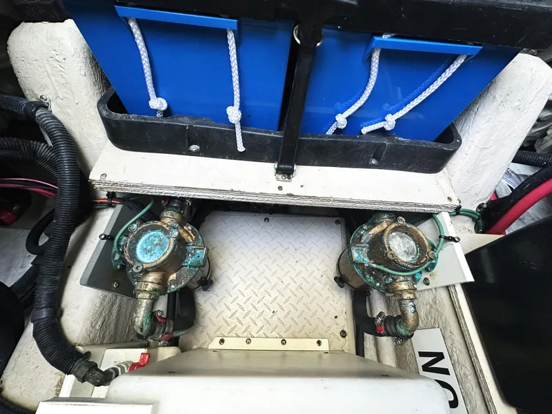 Slide: The Image of Engine compartment of 2006 Sea Ray 48 Sundancer with visible pumps and blue storage. - 31