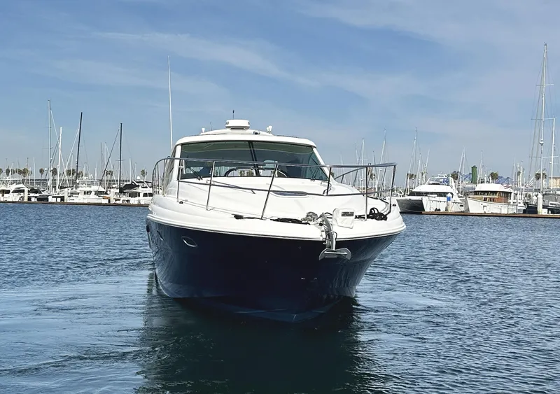Slide: The Image of 2006 Sea Ray 48 Sundancer yacht in marina, front view, calm water, clear sky. - 4